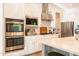 Gourmet kitchen boasts stainless steel appliances, gas cooktop, and double ovens for culinary enthusiasts at 2973 E Austin Dr, Gilbert, AZ 85296