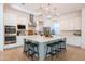 Spacious kitchen featuring an island, modern pendant lighting and stainless steel appliances, perfect for entertaining at 2973 E Austin Dr, Gilbert, AZ 85296