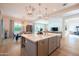 Open kitchen design with island sink, light countertops and a view into the dining and living areas at 2973 E Austin Dr, Gilbert, AZ 85296