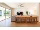 Spacious living room with wooden floors, stylish console tables, a comfortable sofa, and access to the backyard at 2973 E Austin Dr, Gilbert, AZ 85296