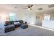 Upstairs living area featuring cozy seating, carpeted floors, and ample natural light from large windows at 2973 E Austin Dr, Gilbert, AZ 85296