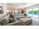 Bright living room featuring a large sectional sofa, open layout, and access to the outdoor pool area at 2973 E Austin Dr, Gilbert, AZ 85296