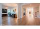 Open living area with hardwood flooring, a tiered chandelier, and views into other living spaces, providing a flowing design at 2973 E Austin Dr, Gilbert, AZ 85296