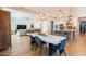 Open-concept living space with dining area, kitchen island and stainless appliances creates a modern, inviting space at 2973 E Austin Dr, Gilbert, AZ 85296