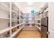 Organized pantry with shelves and storage baskets, plus a mini fridge for efficient food storage at 2973 E Austin Dr, Gilbert, AZ 85296