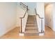 Bright foyer showcases a staircase with wood banister and neutral carpet steps at 2973 E Austin Dr, Gilbert, AZ 85296
