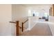 Hallway leading to upstairs living area with carpeted floors and abundant natural light at 2973 E Austin Dr, Gilbert, AZ 85296