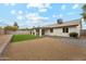 Expansive backyard featuring gravel and artificial turf, complemented by a covered patio and block wall at 3026 E Bremen St, Phoenix, AZ 85032