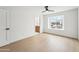 Bright bedroom with a ceiling fan, neutral walls, and a window showcasing the neighborhood view at 3026 E Bremen St, Phoenix, AZ 85032