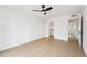 Spacious bedroom with a ceiling fan and easy access to closet and a bathroom at 3026 E Bremen St, Phoenix, AZ 85032