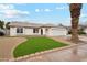 Inviting single-story home with a well-manicured front yard and a two-car garage at 3026 E Bremen St, Phoenix, AZ 85032