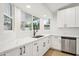 Bright kitchen featuring quartz countertops, stainless steel appliances, and white cabinetry at 3026 E Bremen St, Phoenix, AZ 85032