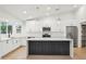 Bright kitchen features white cabinets, modern stainless-steel appliances, and pendant lighting at 3026 E Bremen St, Phoenix, AZ 85032
