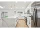 Modern kitchen with white cabinetry, stainless steel appliances, and a large center island at 3026 E Bremen St, Phoenix, AZ 85032