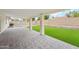 Covered patio area with a paver floor, offering a spacious outdoor living area with views of the backyard at 3026 E Bremen St, Phoenix, AZ 85032