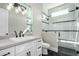 Modern bathroom features a glass shower with a black framed door at 3046 W Redwood Ln, Phoenix, AZ 85045