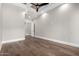 A well-lit bedroom with hardwood flooring, ceiling fan and a neutral color palette at 3046 W Redwood Ln, Phoenix, AZ 85045