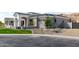 A well-manicured single-story home with neutral color scheme, xeriscaping, and three-car garage at 3046 W Redwood Ln, Phoenix, AZ 85045