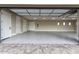 Large three-car garage features painted walls, overhead lighting, and epoxy floor to resist stains at 3046 W Redwood Ln, Phoenix, AZ 85045