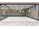 Spacious three-car garage with epoxy flooring, high ceilings, and natural light showcases parking and storage space at 3046 W Redwood Ln, Phoenix, AZ 85045