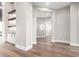 Spacious hallway featuring wood floors, neutral walls, built-in bar, and stylish trim work at 3046 W Redwood Ln, Phoenix, AZ 85045