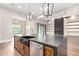Open kitchen design features a large island with a stainless steel dishwasher and granite countertops at 3046 W Redwood Ln, Phoenix, AZ 85045