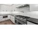 Gourmet kitchen features a professional-grade range, granite counters, and white cabinetry at 3046 W Redwood Ln, Phoenix, AZ 85045