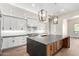 Modern kitchen features white cabinetry, granite countertops, tile backsplash, and contemporary lighting at 3046 W Redwood Ln, Phoenix, AZ 85045