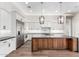 A chef's kitchen with white cabinets, stainless steel appliances, and an island with breakfast bar at 3046 W Redwood Ln, Phoenix, AZ 85045