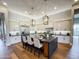 Stylish kitchen with white cabinets, a dark island with seating, and modern pendant lights at 3046 W Redwood Ln, Phoenix, AZ 85045