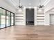 Bright living room with fireplace, custom shelving, and sliding glass doors to outdoor living space at 3046 W Redwood Ln, Phoenix, AZ 85045