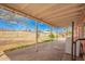 View of a covered back porch overlooking a spacious backyard with chain link fence at 3149 N 40Th Ln, Phoenix, AZ 85019