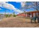 Backyard featuring a dirt area and covered patio next to the coral-colored house at 3149 N 40Th Ln, Phoenix, AZ 85019