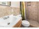 Functional bathroom featuring neutral-toned tile, a shower stall, and a well-lit vanity, combining simplicity and utility at 3149 N 40Th Ln, Phoenix, AZ 85019