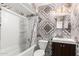 The bathroom features decorative tile, a shower-tub combo, and a single sink vanity at 3149 N 40Th Ln, Phoenix, AZ 85019