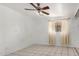 The bright bedroom has tile floors, a ceiling fan, and a window with light-filtering curtains at 3149 N 40Th Ln, Phoenix, AZ 85019