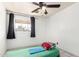 Cozy bedroom features tiled floor, ceiling fan, and black out curtains providing a comfortable, private retreat at 3149 N 40Th Ln, Phoenix, AZ 85019