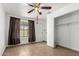 Simple bedroom features a closet, brown curtains, and tiled floor, offering a blank canvas ready for customization at 3149 N 40Th Ln, Phoenix, AZ 85019
