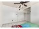 This bedroom features a ceiling fan, tile floor, closet and white walls at 3149 N 40Th Ln, Phoenix, AZ 85019