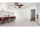 Bright dining area with tile flooring, a ceiling fan, and an adjacent kitchen at 3149 N 40Th Ln, Phoenix, AZ 85019