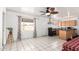 Open kitchen and dining area featuring a ceiling fan, white tile floors, and ample natural light at 3149 N 40Th Ln, Phoenix, AZ 85019