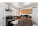 Modern kitchen with stainless steel appliances, granite countertops, and tile flooring at 3149 N 40Th Ln, Phoenix, AZ 85019