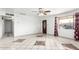 Spacious living room featuring large windows, tile flooring, and a ceiling fan at 3149 N 40Th Ln, Phoenix, AZ 85019