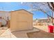 Image shows a tan colored Tuff Shed in the backyard with some storage items nearby at 3149 N 40Th Ln, Phoenix, AZ 85019