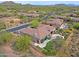 Aerial view of a gorgeous desert home with lush desert landscaping, pool, putting green, and patio area at 33242 N 68Th Pl, Scottsdale, AZ 85266