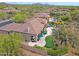 Stunning aerial view of a desert home showcasing a putting green, pool, and lush landscaping, perfect for outdoor living at 33242 N 68Th Pl, Scottsdale, AZ 85266