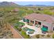 Resort-style backyard featuring a pool, spa, putting green, outdoor seating, and desert landscape at 33242 N 68Th Pl, Scottsdale, AZ 85266