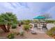 Inviting backyard featuring comfortable seating, lush desert landscaping, and a tranquil pool area for relaxation at 33242 N 68Th Pl, Scottsdale, AZ 85266