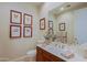Well-lit bathroom features a vanity, framed botanical prints, and fresh decor at 33242 N 68Th Pl, Scottsdale, AZ 85266