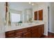 Bathroom featuring dual vanities, large mirror, and wood floors at 33242 N 68Th Pl, Scottsdale, AZ 85266